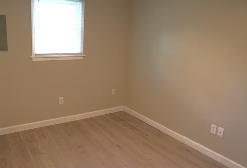Unfurnished room featuring light wood-style floors and electric panel