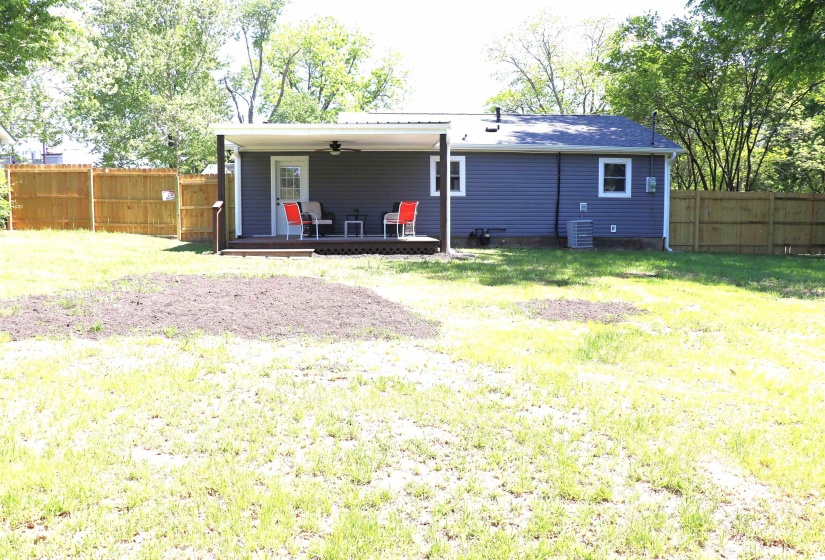 Rear view of house featuring ceiling fan, a fenced backyard, and a wooden deck