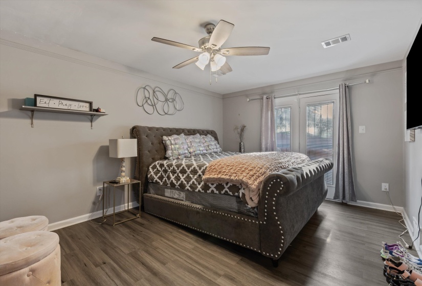 Bedroom featuring dark wood finished floors, access to exterior, ceiling fan, and ornamental molding