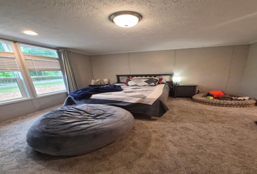 Bedroom with carpet flooring and a textured ceiling