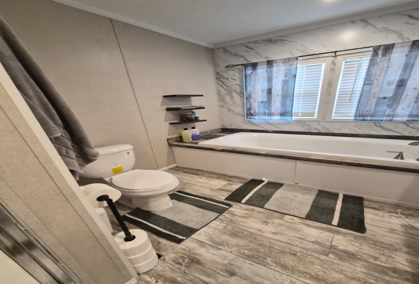 Bathroom featuring light wood finished floors and crown molding