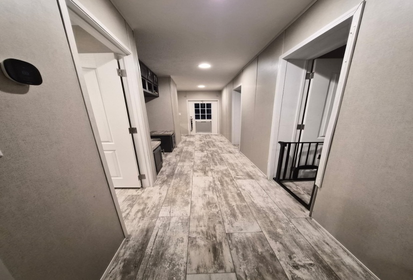 Hall with light wood-style flooring and recessed lighting