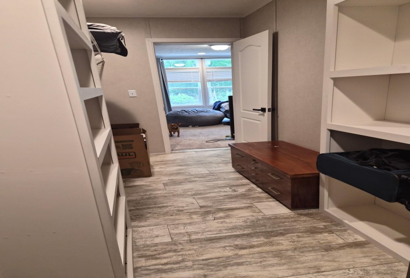 Walk in closet with light wood-type flooring