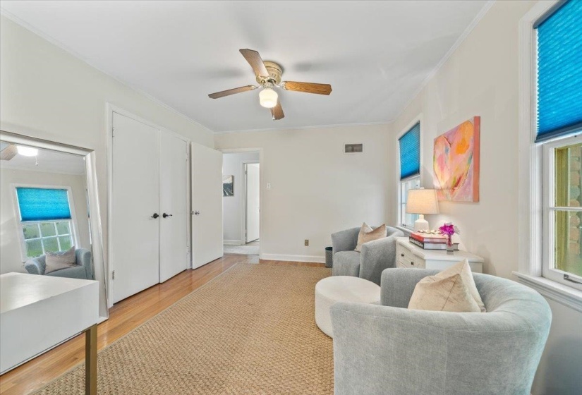 Living room featuring crown molding, ceiling fan, and wood finished floors