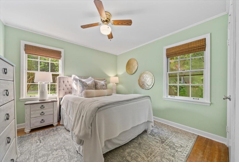 Bedroom with crown molding, a ceiling fan, and wood finished floors