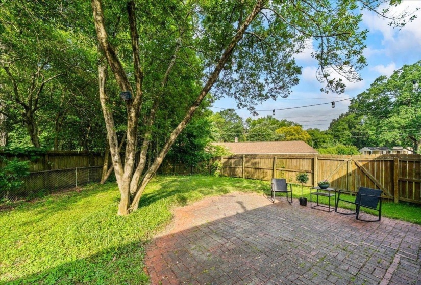 Fenced backyard with a patio