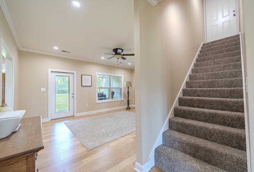 Foyer entrance with recessed lighting, light wood-style floors, crown molding, and a ceiling fan