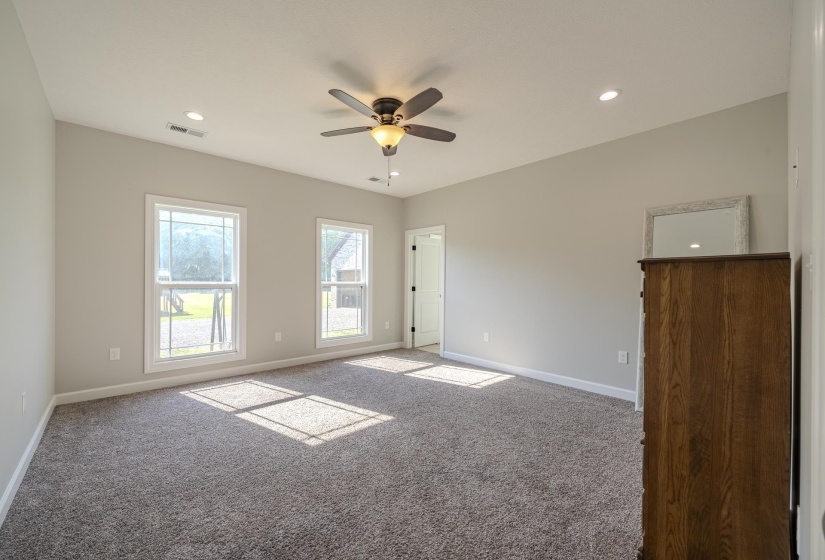 Carpeted spare room with ceiling fan and recessed lighting