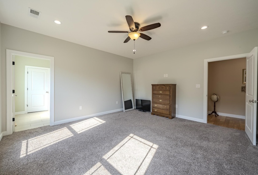 Unfurnished bedroom featuring carpet, a ceiling fan, and recessed lighting