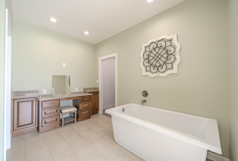 Full bathroom with vanity, a soaking tub, recessed lighting, and light tile patterned floors