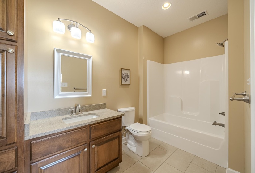 Full bathroom with vanity, light tile patterned flooring, bathtub / shower combination, and recessed lighting