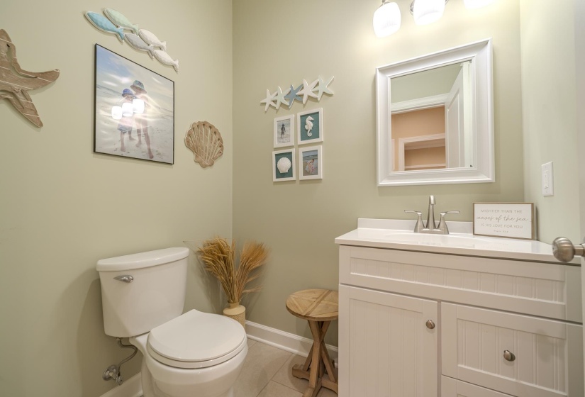 Half bathroom featuring vanity and light tile patterned flooring