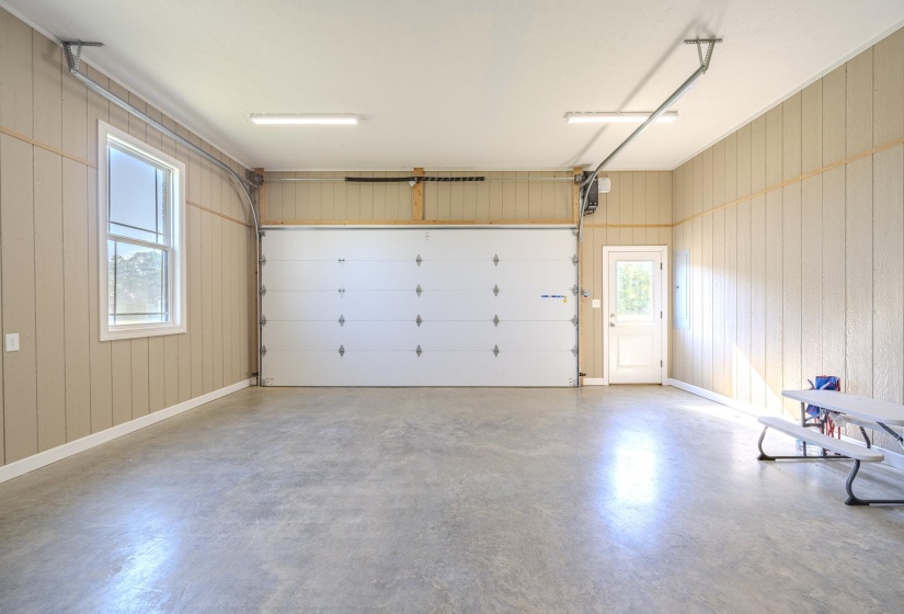 Garage with wood walls and baseboards