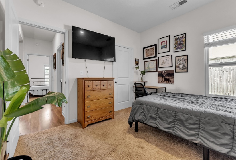 Bedroom featuring light carpet
