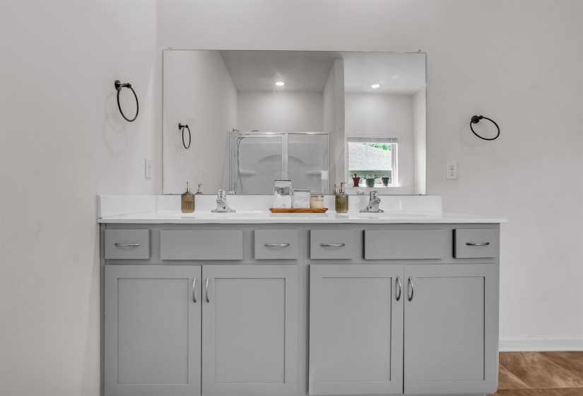 Bathroom with a stall shower and double vanity