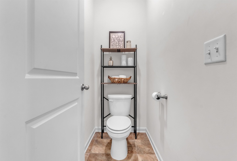 Bathroom with baseboards and light stone finish floors