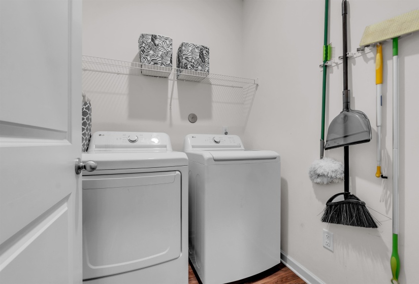 Laundry area with washing machine and dryer and light wood-type flooring