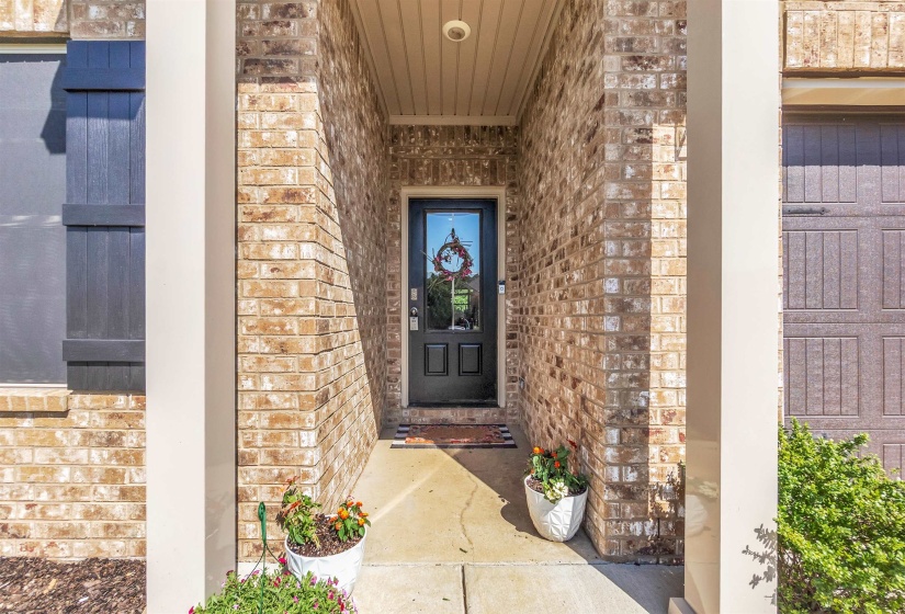 Entrance to property with brick siding