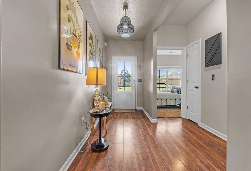 Entryway with hardwood / wood-style flooring and a textured ceiling