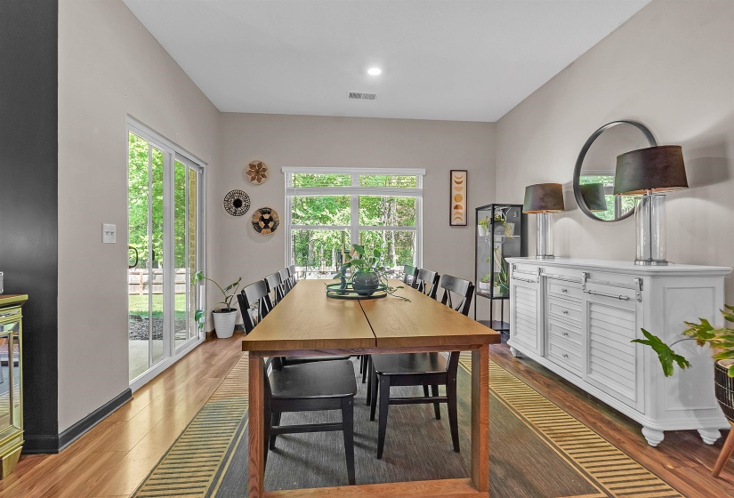 Dining space with wood finished floors and plenty of natural light