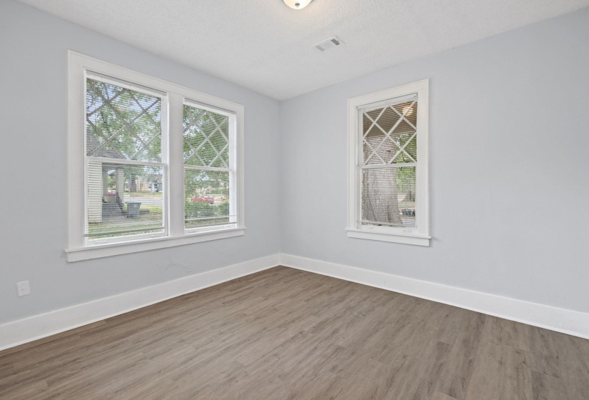 Empty room with wood finished floors and a textured ceiling