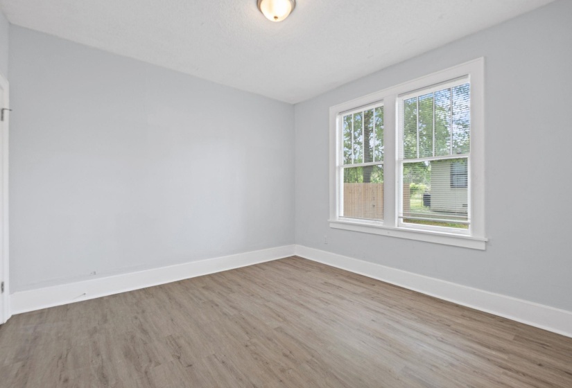 Unfurnished room featuring light wood-type flooring and baseboards