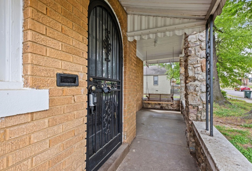 View of exterior entry with a porch