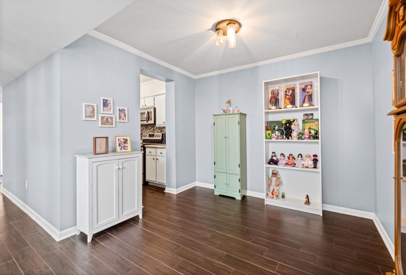 Rec room with ornamental molding and wood tiled floors