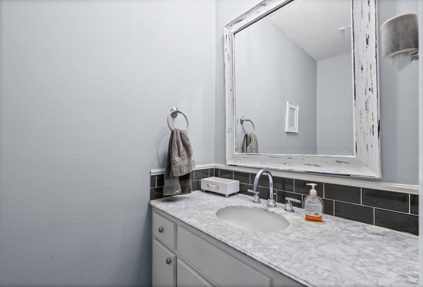 Bathroom with vanity and decorative backsplash