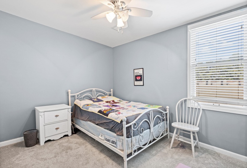 Bedroom with light carpet and ceiling fan