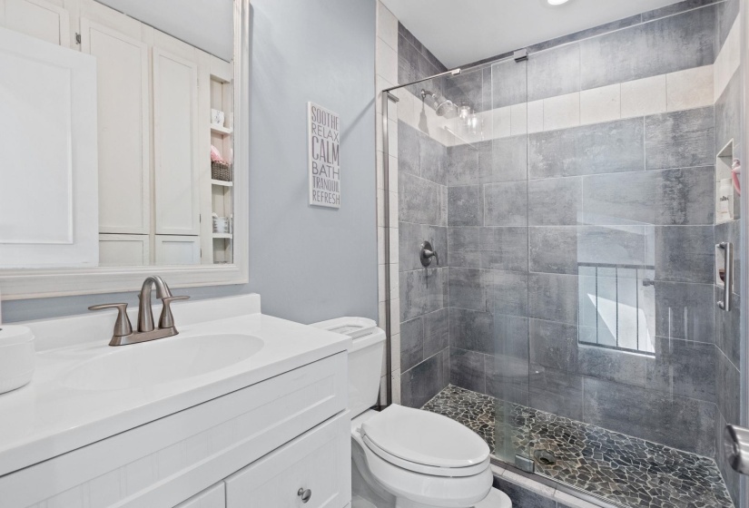 Full bath with vanity and a shower stall