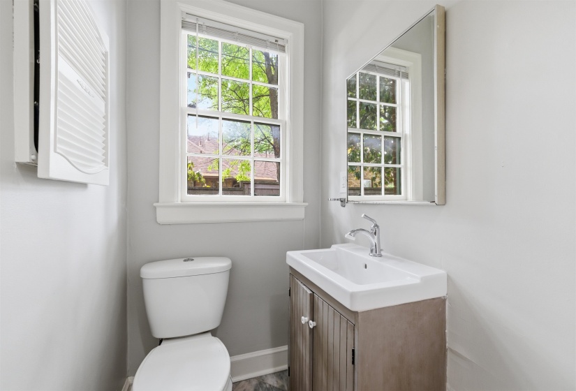 Half bathroom featuring vanity and toilet