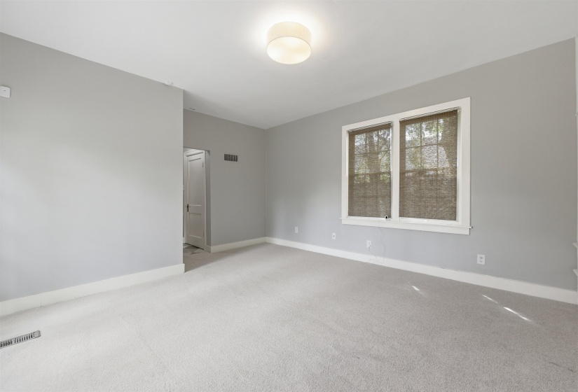 Spare room featuring light colored carpet and baseboards
