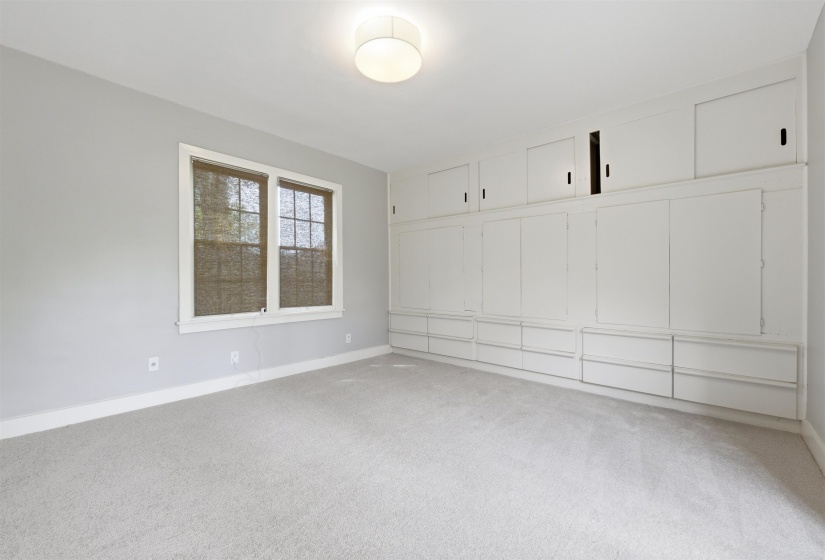 Unfurnished bedroom featuring light colored carpet and a closet
