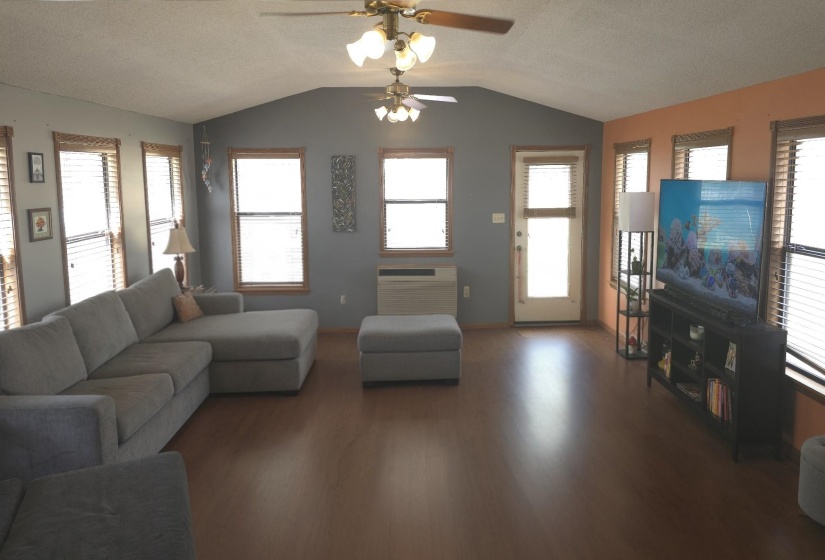 Living room featuring wood finished floors, ceiling fan, and a textured ceiling