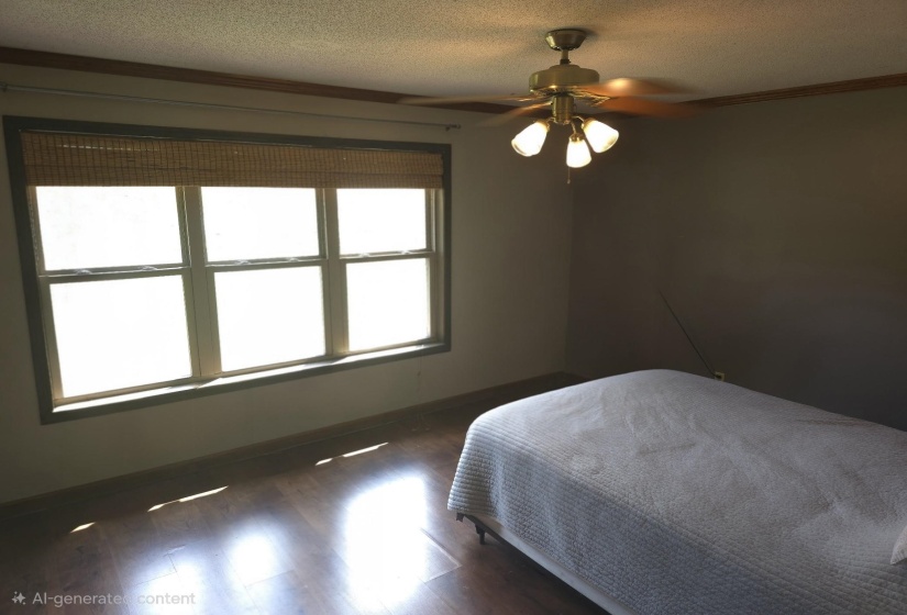 Bedroom featuring a textured ceiling, dark wood-style flooring, and a ceiling fan