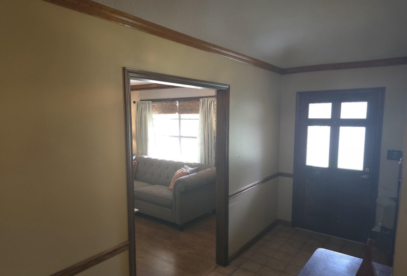 Entrance foyer featuring ornamental molding and baseboards