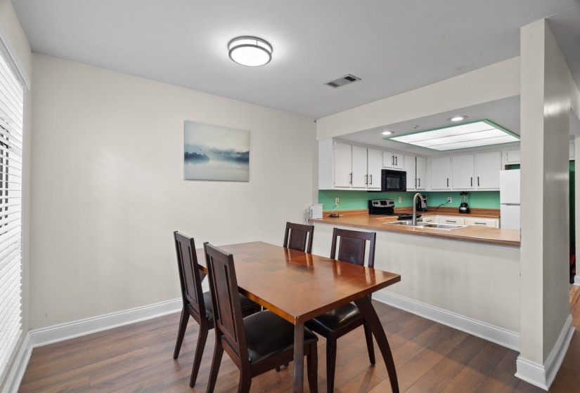Dining area featuring dark wood-style flooring