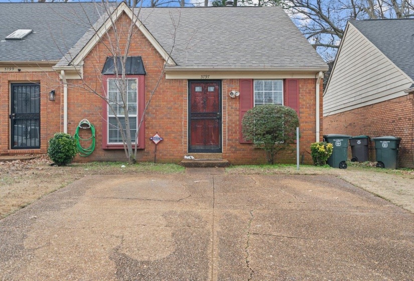 View of front of home with a shingled roof and brick siding