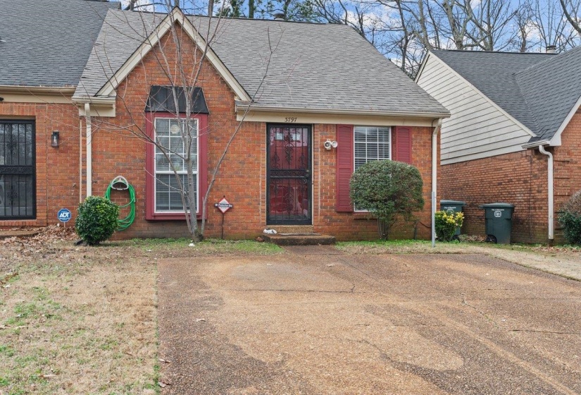 View of front of house featuring brick siding and a shingled roof