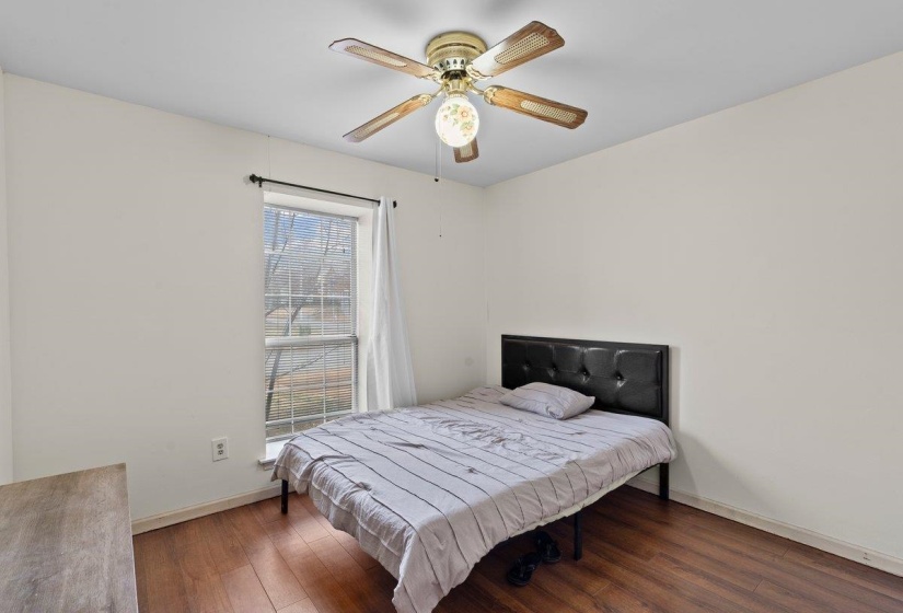 Bedroom with hardwood / wood-style floors and a ceiling fan