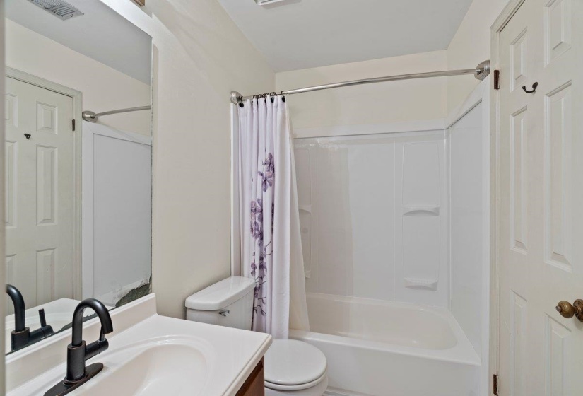 Bathroom featuring vanity and shower / bath combo