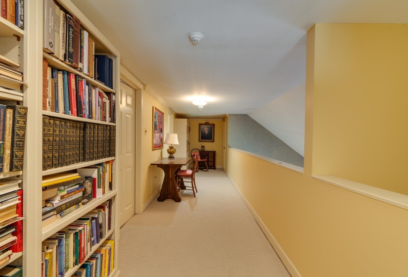 Hall with light carpet and lofted ceiling