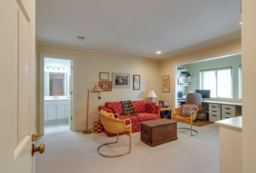 Living room featuring light carpet, crown molding, a desk, and recessed lighting