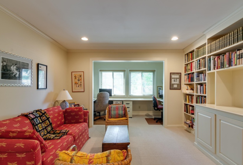 Living area with an office area, crown molding, light colored carpet, and recessed lighting