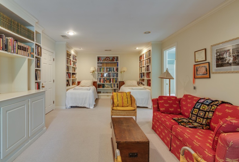 Living room featuring ornamental molding, light colored carpet, built in features, and recessed lighting