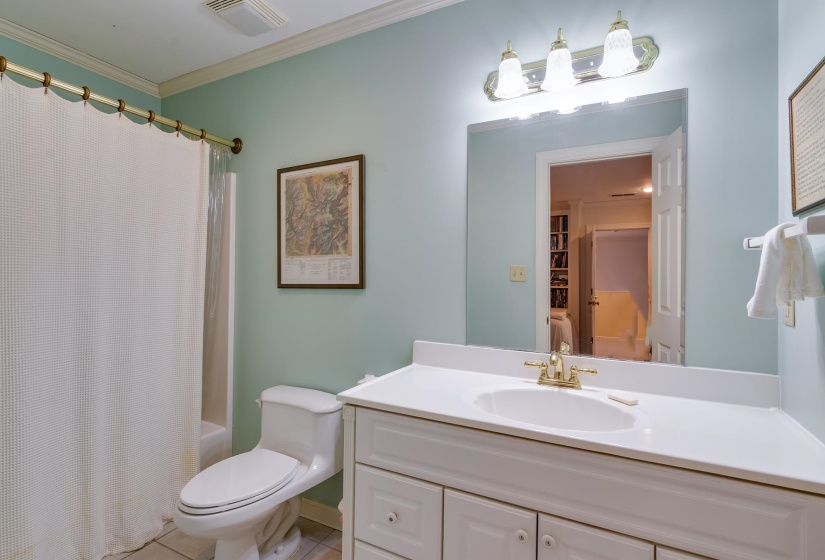 Full bathroom featuring vanity, crown molding, and shower / tub combo