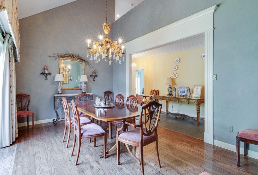 Dining space featuring wood-type flooring and a chandelier