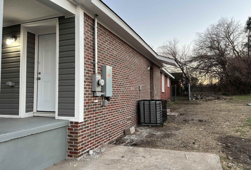 View of property exterior featuring brick siding