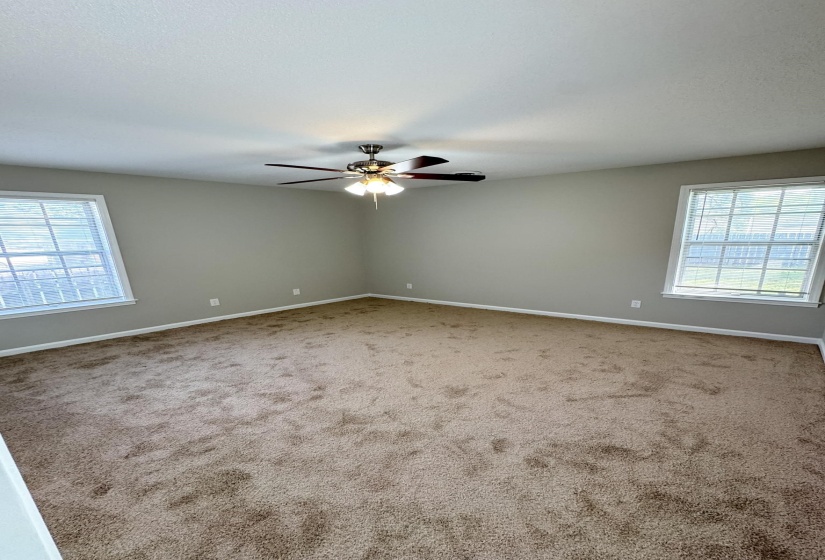 Unfurnished room with a ceiling fan and carpet floors